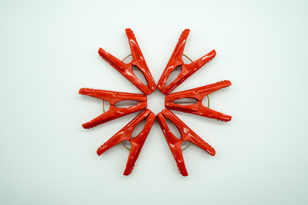 Red cloth clips isolated on white background. Cloth pin arrangement for flower concept. Creative art with preschool kid at home.の写真素材