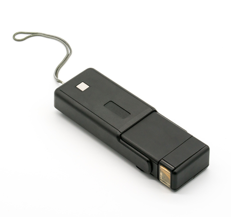 Tilt and isometric view of an old vintage point and shoot 135mm film camera isolated over white background.の写真素材