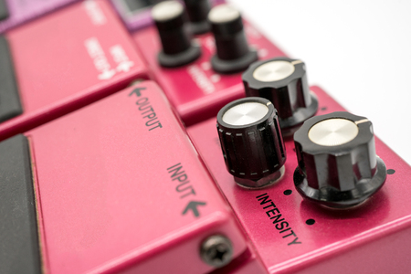 Close-up detail of vintage guitar pedals isolated on white background. Vintage pedal knobs.の写真素材