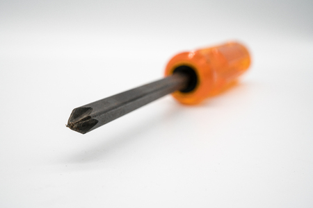 Black Phillips tip of manual screwdriver isolated on white background. Macro focus.