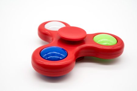 Spinning black fidget aluminum spinner isolated on white background.の写真素材