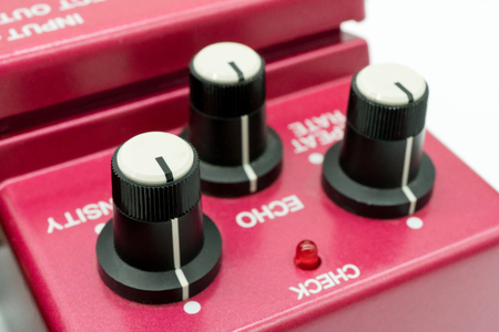 closeup of vintage guitar pedal isolated on white background