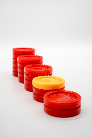 Row of different coin rising stacks isolated on white background. Symbolic image for money allocation and expense with financial crisis concept.の写真素材