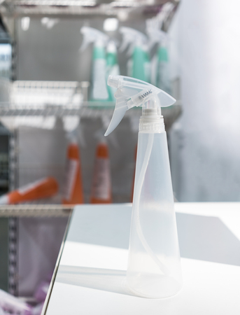 Empty transparent foggy spry bottle on white deskの写真素材