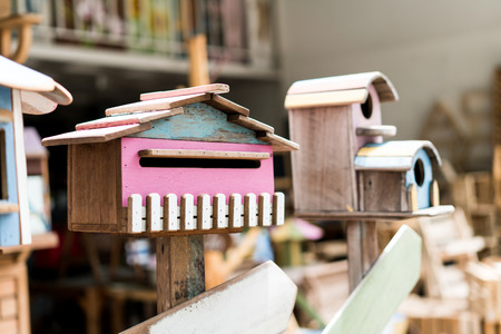 Retro colorful bird house on wood stand   in vintage storeの写真素材