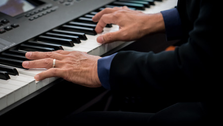 Pianist playing electric piano in concert, music conceptの写真素材