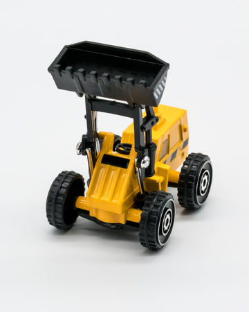 Heavy crawler toy bulldozer isolated on a white background. Tractor truck toy
