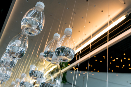 Water bottle floating and acting as an installation art in public parkの写真素材