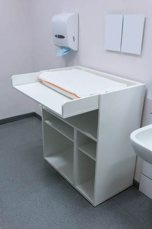 baby changing diapers bed in public toiletの写真素材