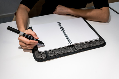 Woman sitting on office desk and planning for project timeline.