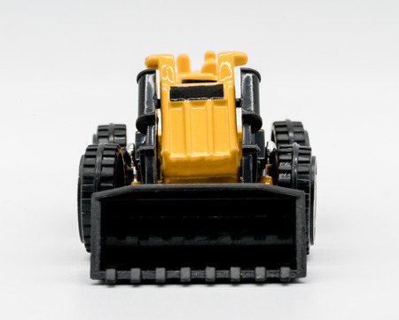 Heavy crawler toy bulldozer isolated on a white background. Tractor truck toyの写真素材