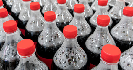 plastic bottles with carbonated soft drinks background