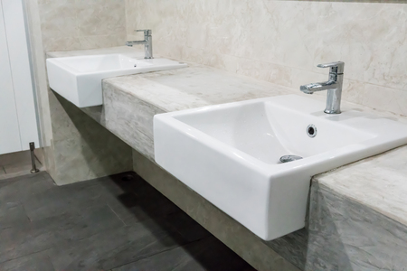 Minimal style bathroom with two sinks and granite vanity topの写真素材