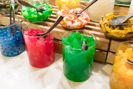 Thai sweet topping in cylinder glass containers for traditional thai coconut milk ice cream and...