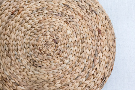 Closed up round wicker pot coaster isolated on white background for texture and pattern.の写真素材
