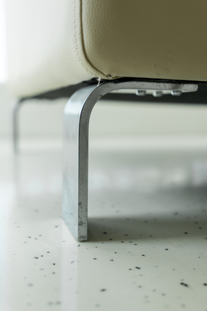 Detail of silver metal sofa leg. Furniture hardware fitting underneath modern couch.の写真素材