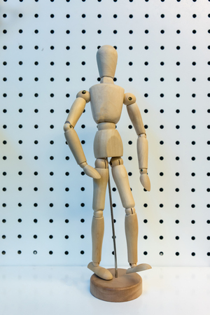 3D wooden figure posing walking action isolated on white perforated background.の写真素材