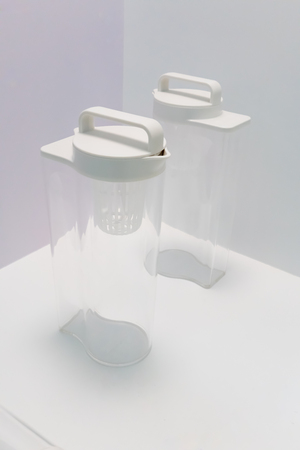 Acrylic water bottle with easy-to-carry plastic cap standing on white background.の写真素材