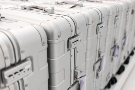 Security pad lock of silver metal luggage in the luggage row. Selective focus and perspective view. Luggage wholesale.の写真素材