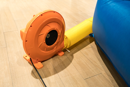 Colorful electric air blower for commercial inflatable bouncer and slide in kid play land.の写真素材