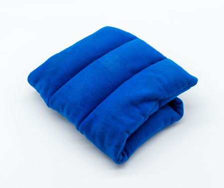 Blue microwave heating pad isolated on white background. Cold and hot wrap for shoulder,  neck, back, and body pain relief therapy.の写真素材