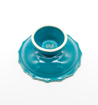 Bangkok, Thailand - Dec 23, 2017: Vintage ceramic ashtray in blue green color with vintage Thai graphic cigarette packagingのeditorial素材