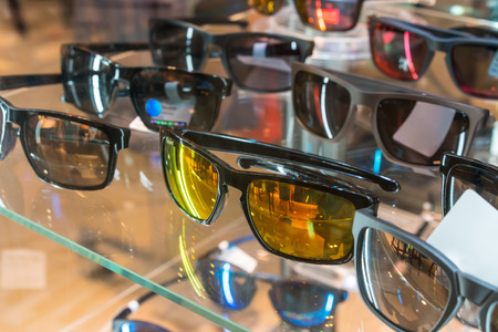 Various of sun glasses in the shop display shelves. Selective focusの写真素材