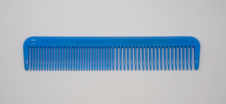 Blue plastic comb isolated on white backgroundの写真素材
