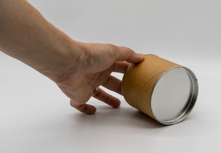 Hand rotaing cylinder container with metal or tin lid isolated on white background
