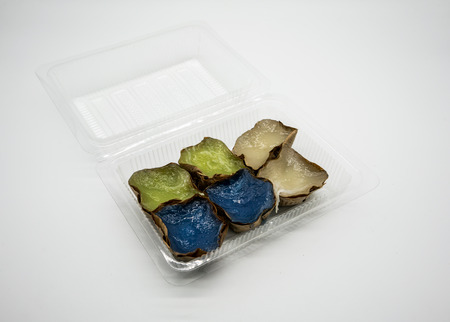 Chinese New Year's cake. Chinese pudding in clear plastic contaniner isolated on white background