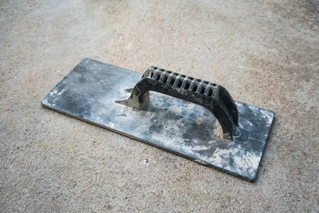 rusty and dirty trowel plastering on concrete cement floorの写真素材