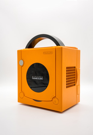 Bangkok, Thailand - March 7, 2018: Nintendo Gamecube Console in orange color, Vintage portable game by Nintendo. Illustrative, editorial.のeditorial素材