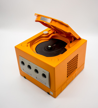 Bangkok, Thailand - March 7, 2018: Nintendo Gamecube Console in orange color, Vintage portable game by Nintendo. Illustrative, editorial.のeditorial素材