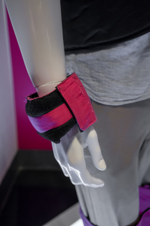 White mannequin model wearing pink adjustable training weight bag on wrist.の写真素材