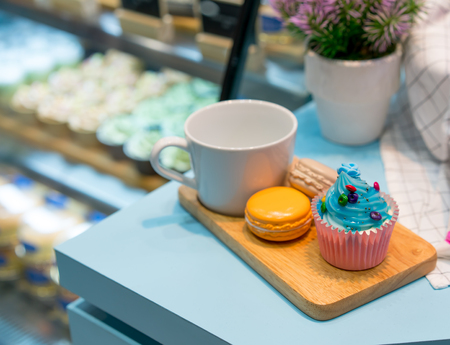 Artificial cupcake and biscuit on wooden plate for decoration in restaurant or cafeの写真素材