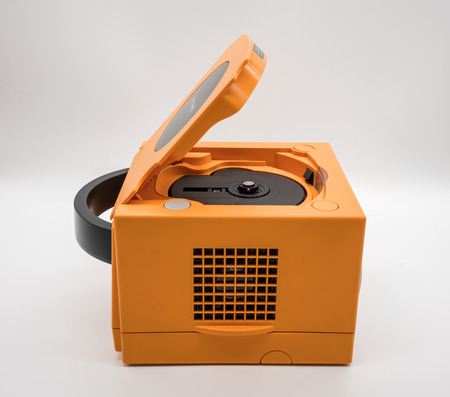 Bangkok, Thailand - March 7, 2018: Nintendo Gamecube Console in orange color, Vintage portable game by Nintendo. Illustrative, editorial.のeditorial素材