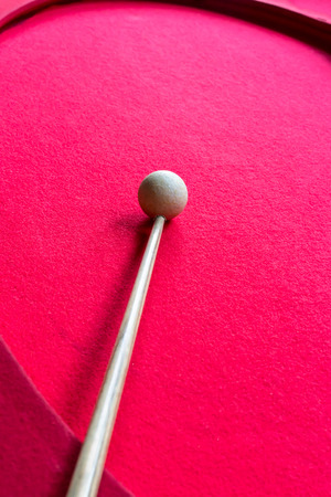 Billiard balls on the red baize of an oval shape billiard table.