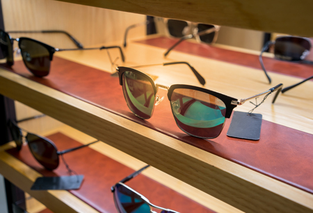 Various of colorful sun glasses in the shop display shelves. Selective focusの写真素材