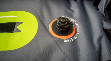 Pressure connector of grey and green inflatable kayak made from polyurethane fabric