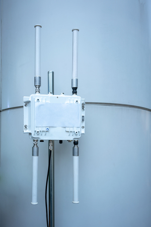 Huge wireless   router for network hanging on white wall. World wide network technology.