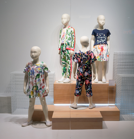 H & M shop at Fashion Island, Bangkok, Thailand, Mar 22, 2018 : Fashionable kids clothing brand in spring collection window display in front of the shop.のeditorial素材