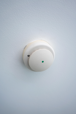 Used smoke detector of fire alarm isolated on white backgroundの写真素材