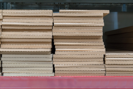 Piles or stacks of paper boxes with goods in storage. Cardboard boxes.