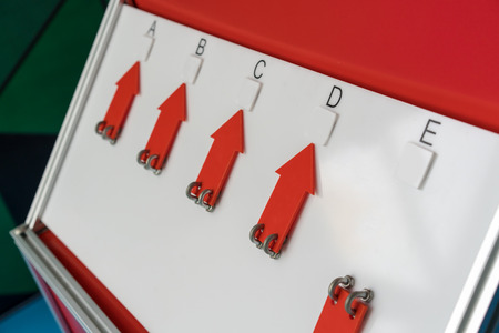 Answering board with red arrows for educational activity in classroom. Living concept with too many...