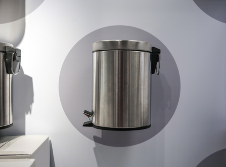 Stainless modern trash can on grey and white wall for display in storeの写真素材