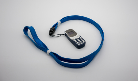 World smallest mobile phone with OLED screen in blue plastic body isolated on white background