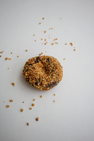 Single ground peanut coated on chocolate flour donut isolated on white background.の写真素材