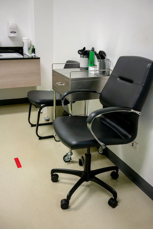 Awaiting seat in eye examination room. Eye testing interior.の写真素材