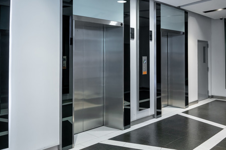 Modern steel elevator cabins in a business lobby or Hotel, Store, interior, office,perspective wide...