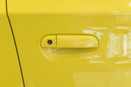 Yellow car door handle. Car exterior detail for modern carの写真素材